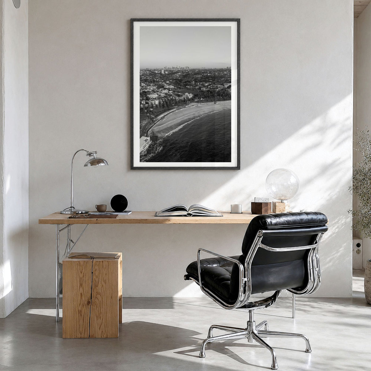 Coogee Beach Photo Poster in a black wood frame, hanging in a bright home office, white border