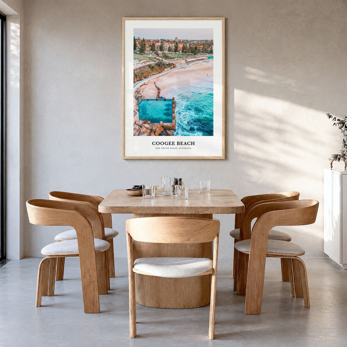 Coogee Beach Classic No 1 Poster in a natural wood frame, hanging in a dining room