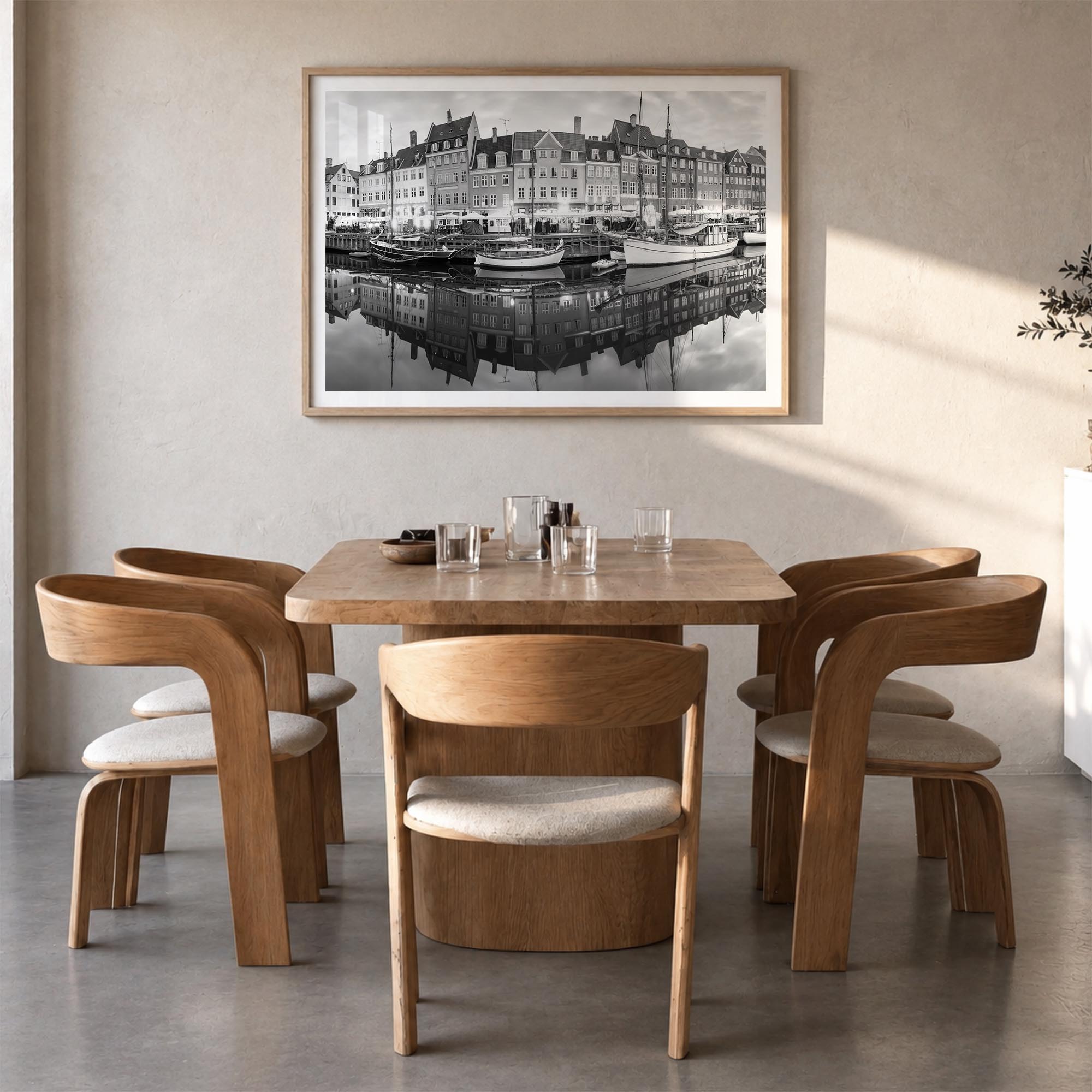 Copenhagen black & white photo poster of Denmark – horizontal wall art in natural wood frame with white border, hanging on wa