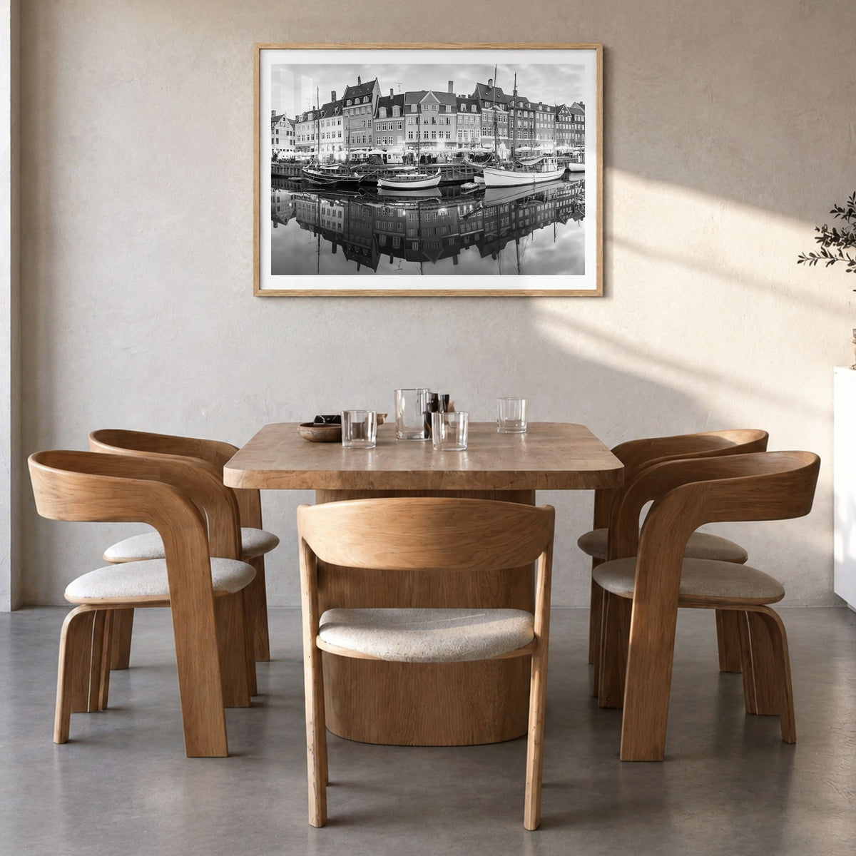 Copenhagen Photo Poster in a natural wood frame, hanging in a dining room, white border