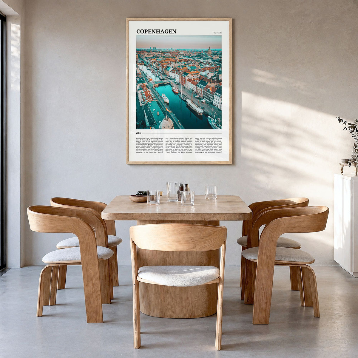 Copenhagen Travel Poster in a natural wood frame, hanging in a dining room