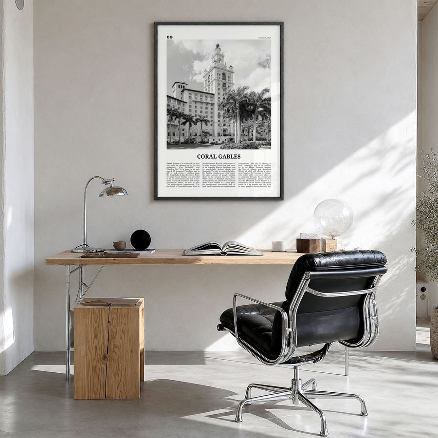 Coral Gables Newspaper Poster in a black wood frame, hanging in a bright home office