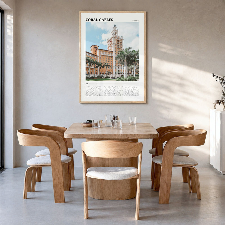 Coral Gables Travel Poster in a natural wood frame, hanging in a dining room
