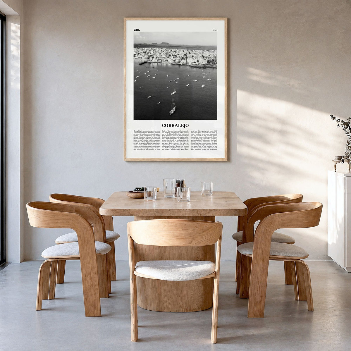 Corralejo Newspaper Poster in a natural wood frame, hanging in a dining room