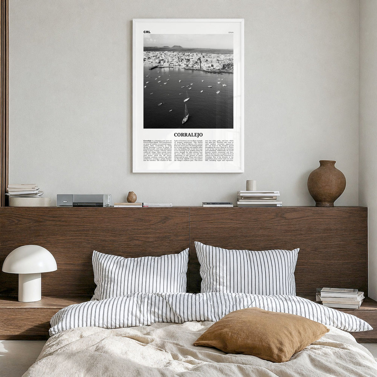 Corralejo Newspaper Poster in a white wood frame, hanging in a bedroom