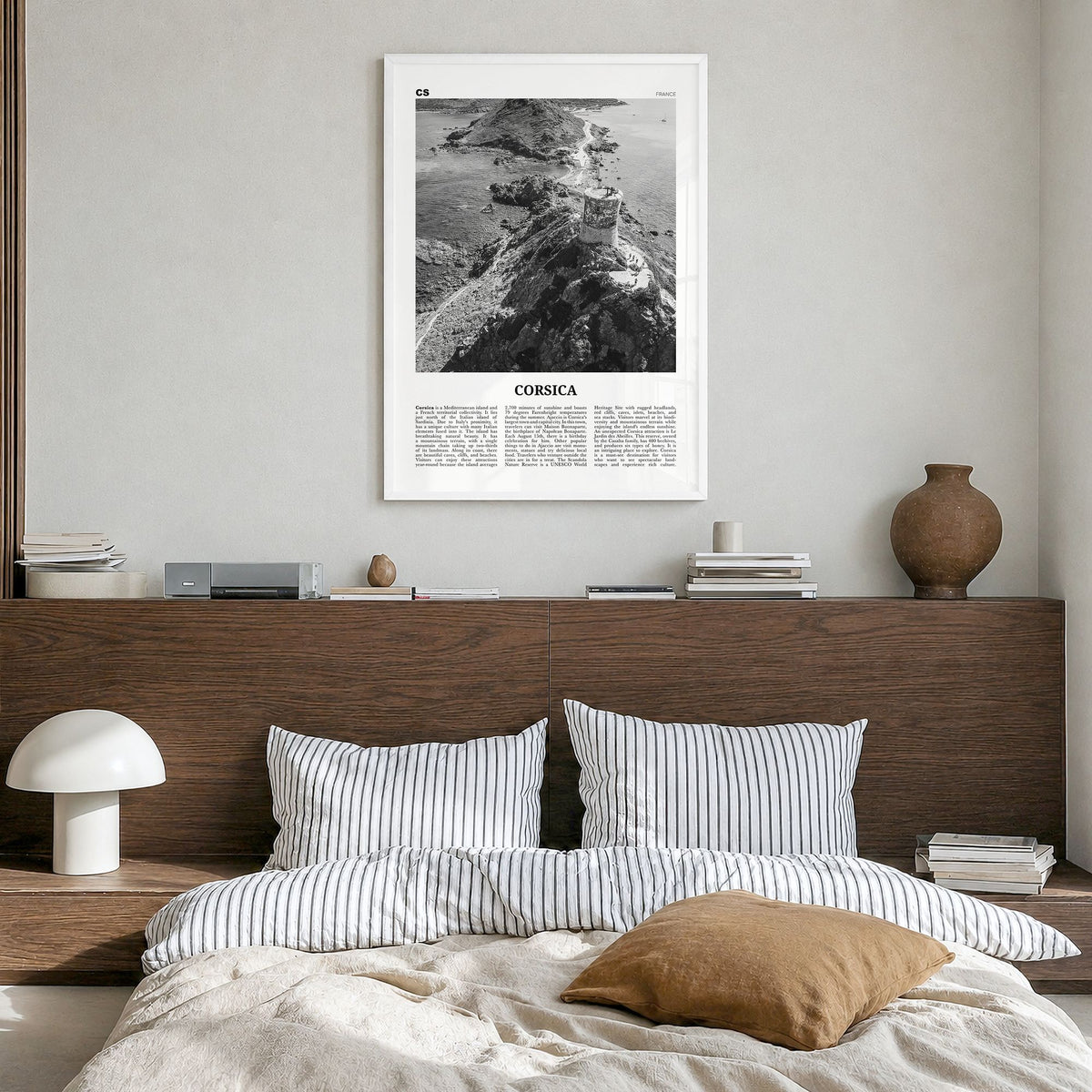 Corsica Newspaper Poster in a white wood frame, hanging in a bedroom