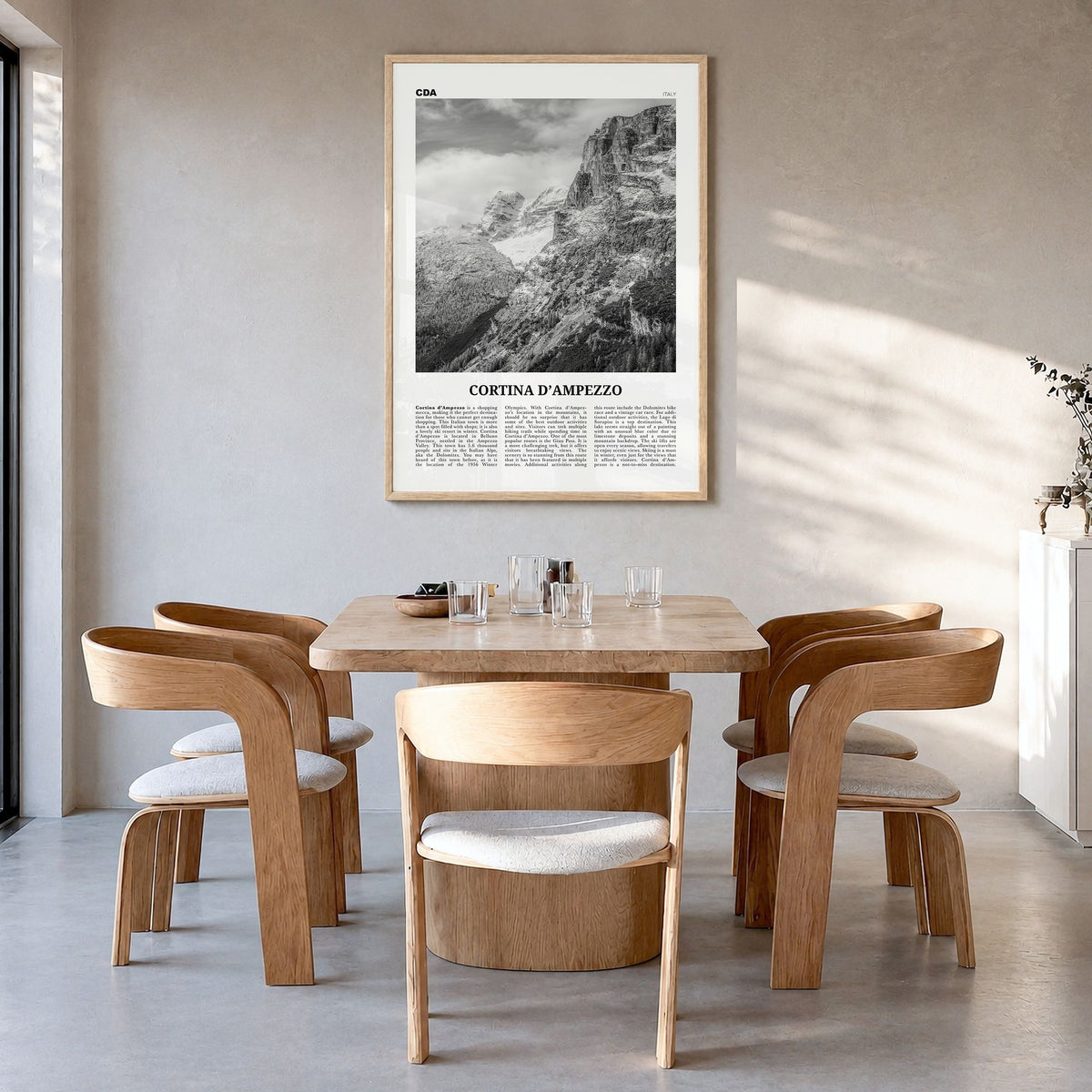 Cortina d'Ampezzo Newspaper Poster in a natural wood frame, hanging in a dining room