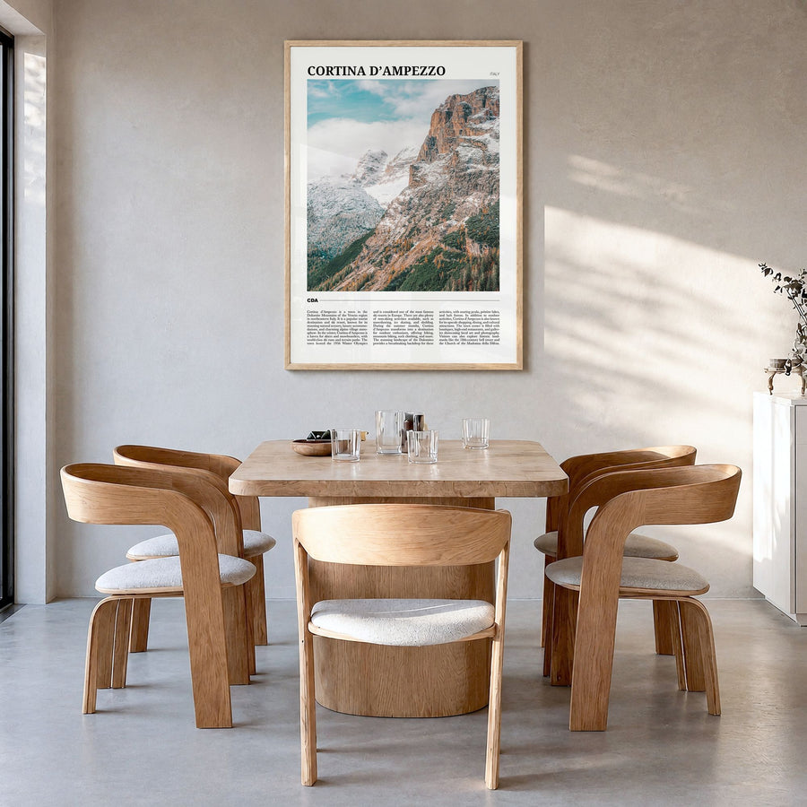 Cortina d'Ampezzo Travel Poster in a natural wood frame, hanging in a dining room