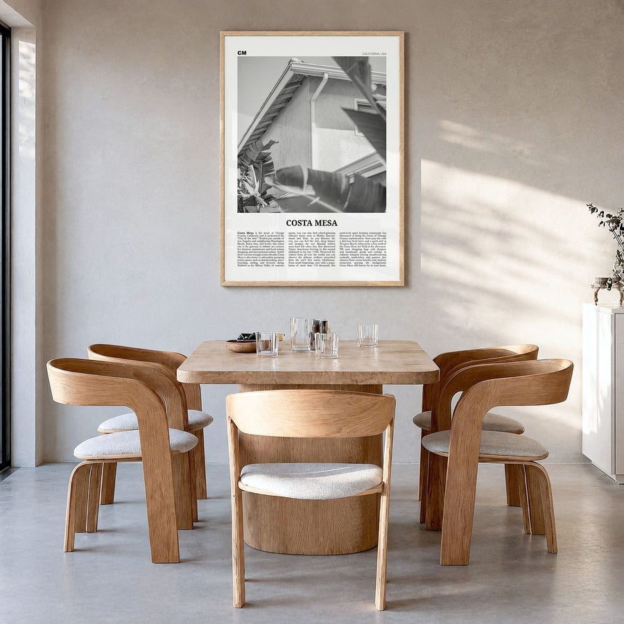 Costa Mesa Newspaper Poster in a natural wood frame, hanging in a dining room