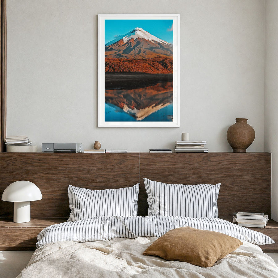 Cotopaxi Photo Poster in a white wood frame, hanging in a bedroom, white border
