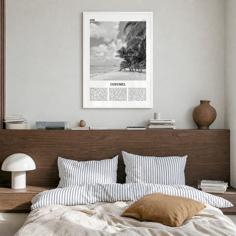 Cozumel Newspaper Poster in a white wood frame, hanging in a bedroom