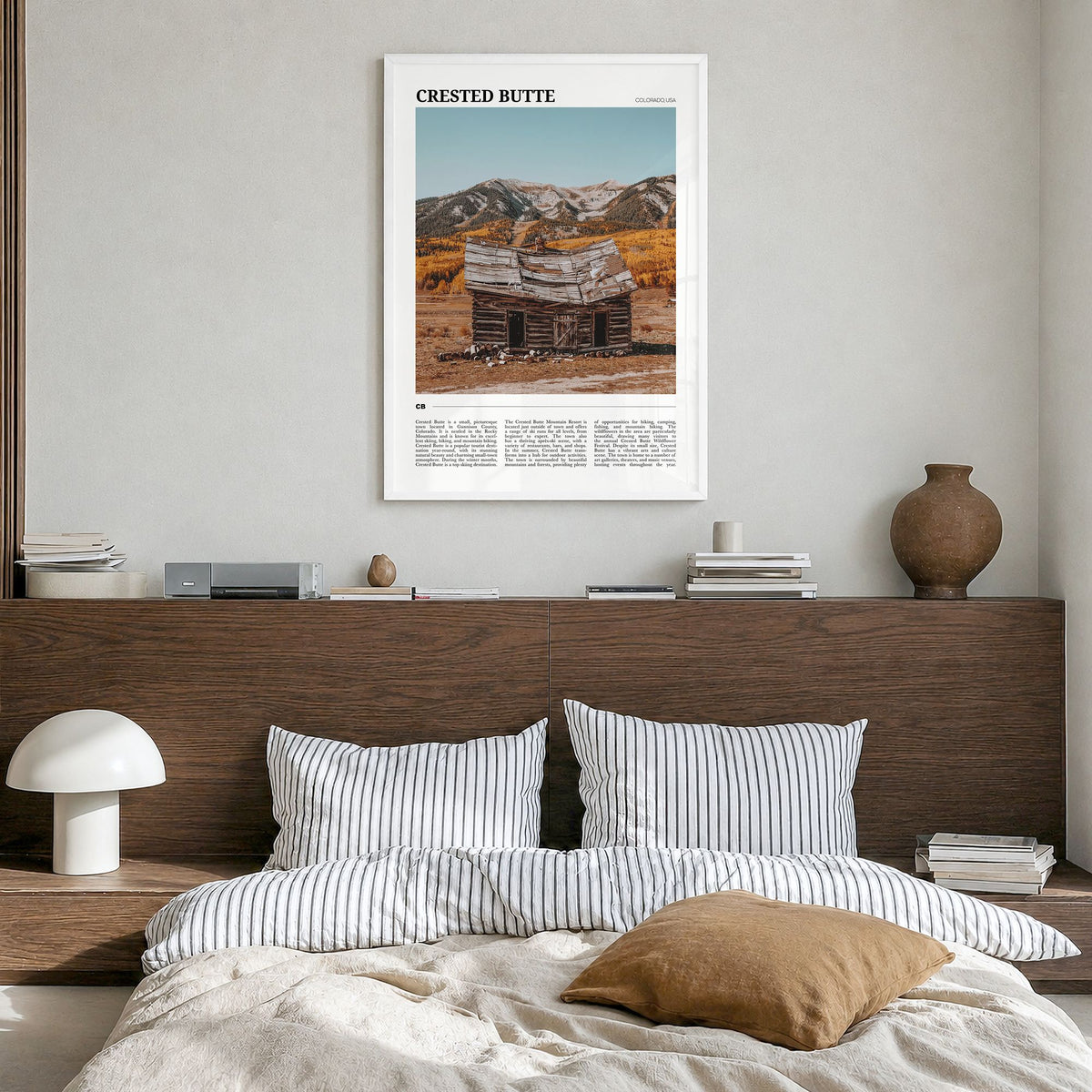 Crested Butte Travel Poster in a white wood frame, hanging in a bedroom