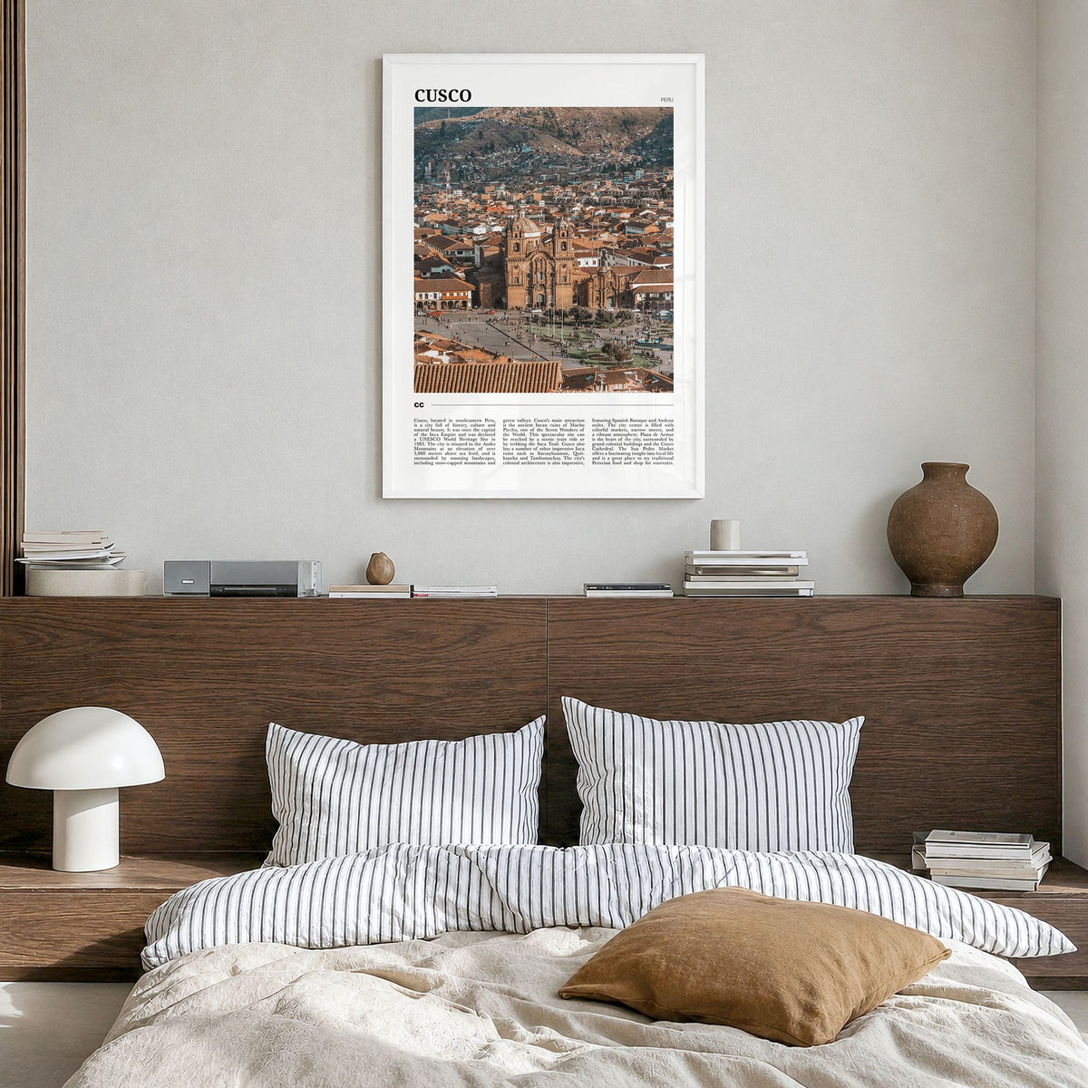 Cusco Travel Poster in a white wood frame, hanging in a bedroom