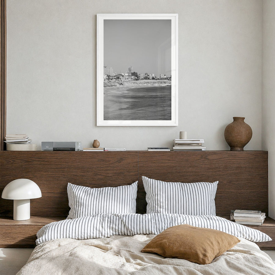 Dakar Photo Poster in a white wood frame, hanging in a bedroom, white border