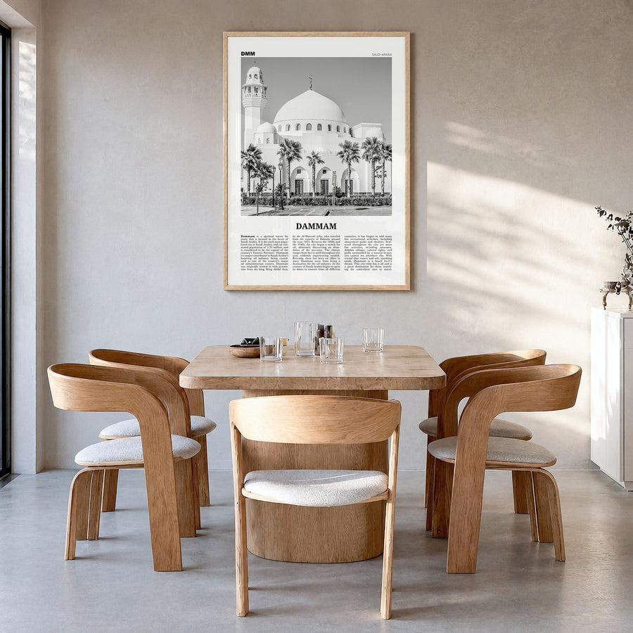 Dammam Newspaper Poster in a natural wood frame, hanging in a dining room