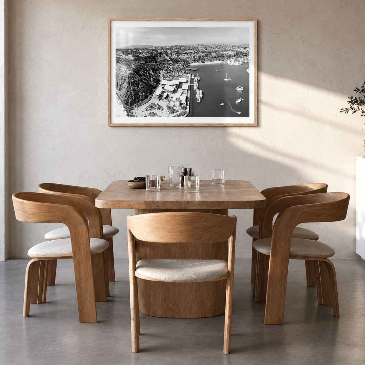 Dana Point Photo Poster in a natural wood frame, hanging in a dining room, white border