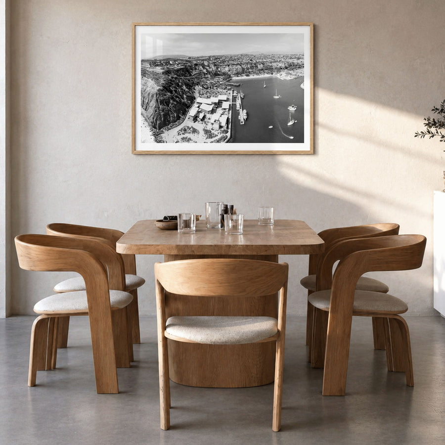 Dana Point Photo Poster in a natural wood frame, hanging in a dining room, white border