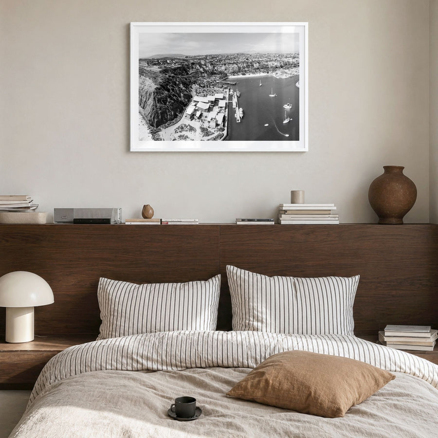 Dana Point Photo Poster in a white wood frame, hanging in a bedroom, white border