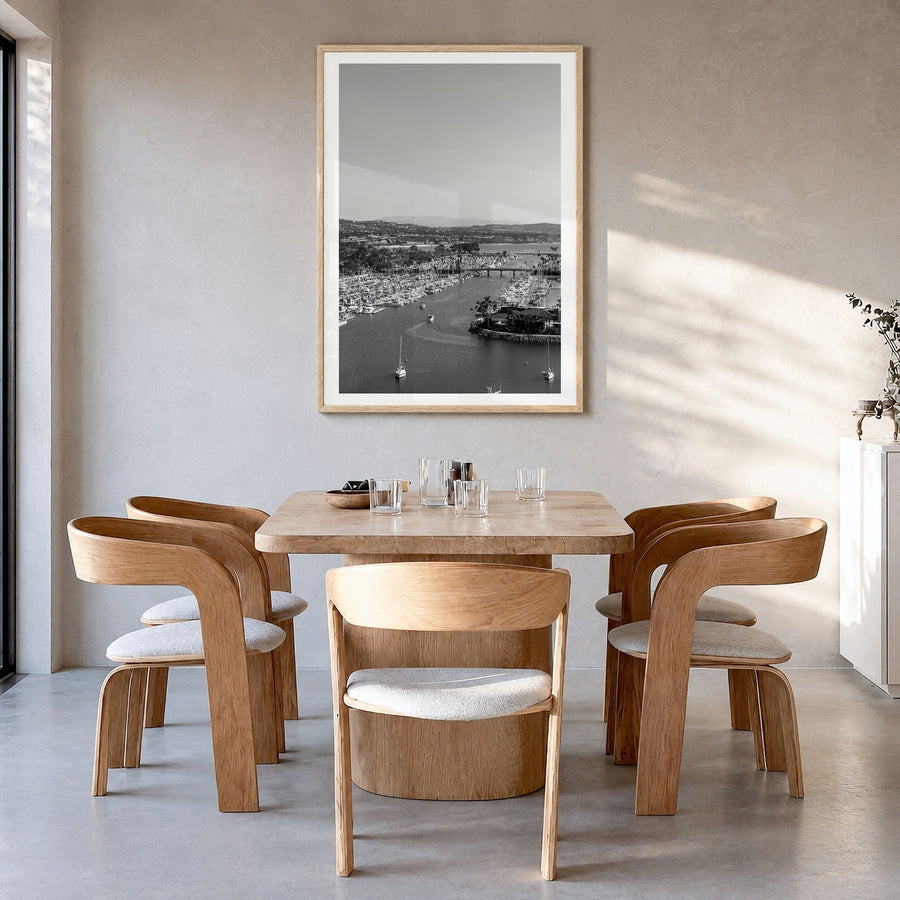 Dana Point Photo Poster in a natural wood frame, hanging in a dining room, white border