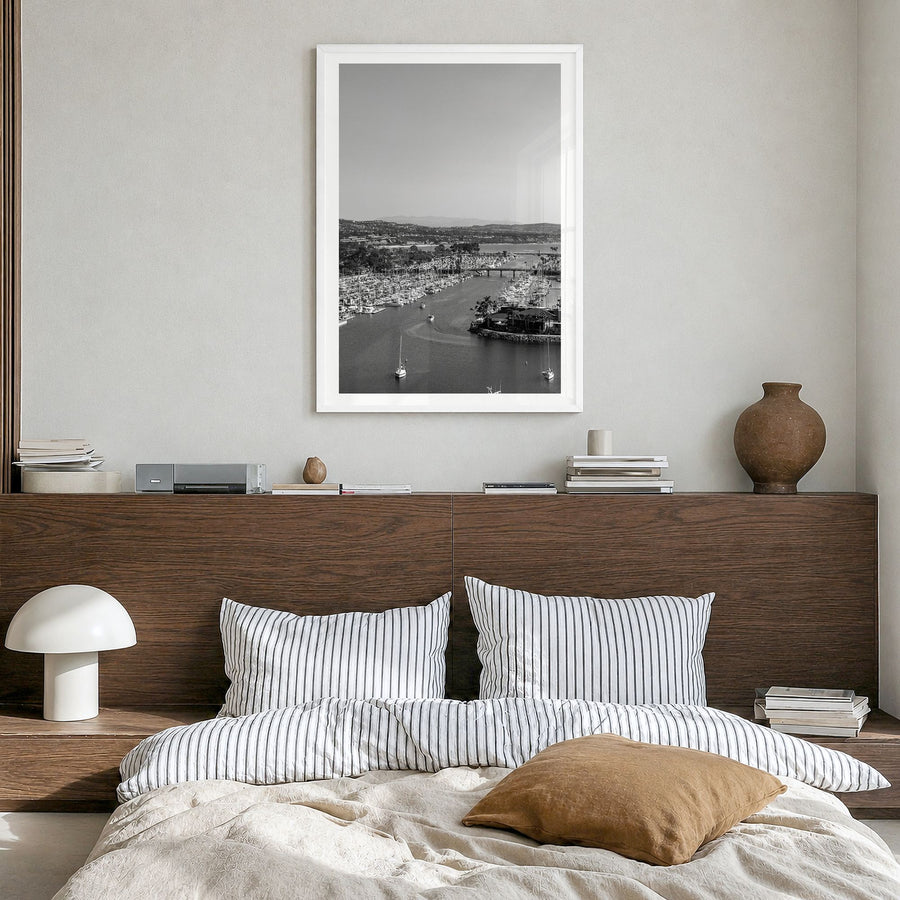 Dana Point Photo Poster in a white wood frame, hanging in a bedroom, white border