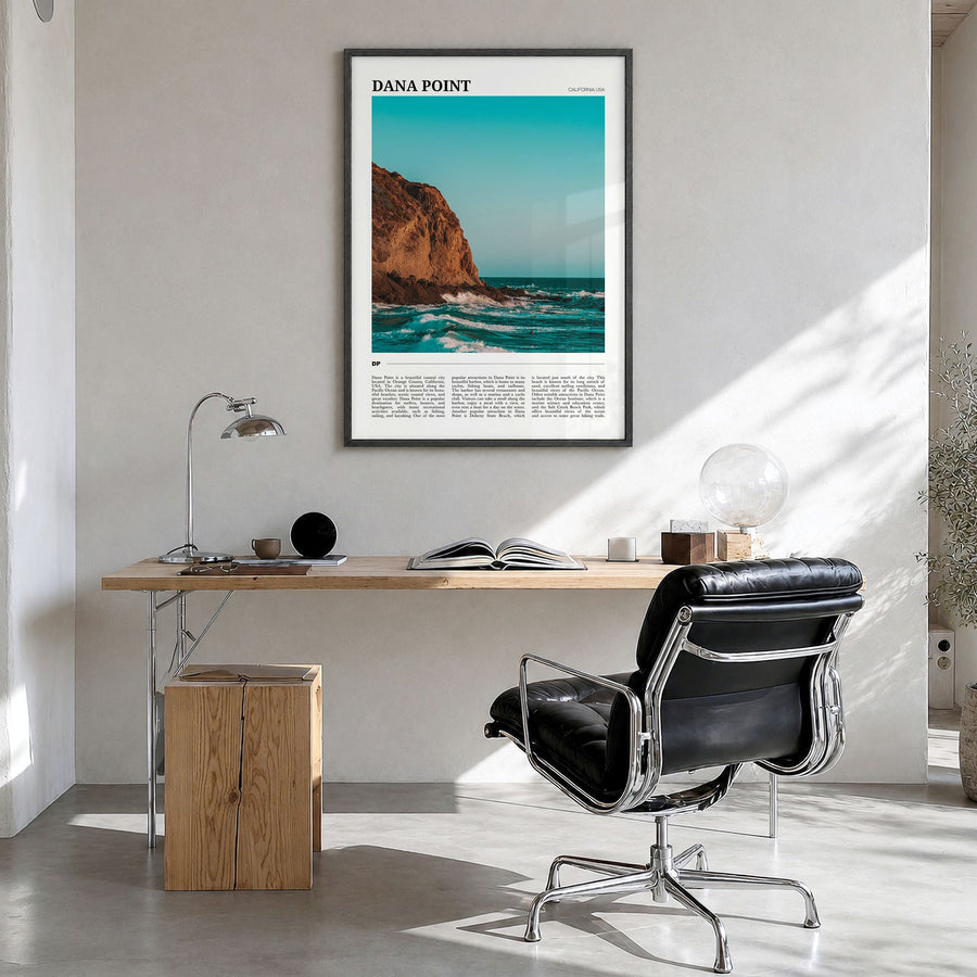 Dana Point Travel Poster in a black wood frame, hanging in a bright home office