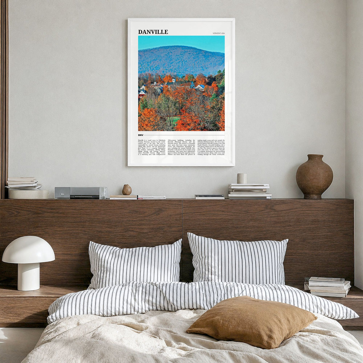 Danville, Vermont Travel Poster in a white wood frame, hanging in a bedroom