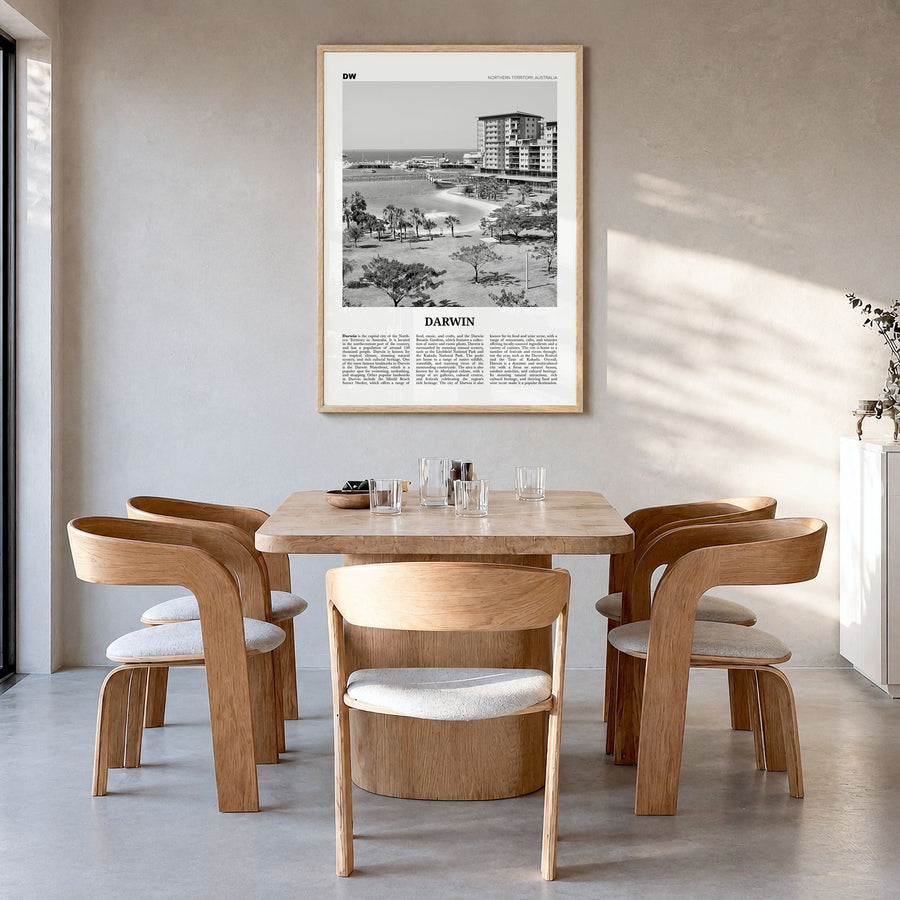 Darwin Newspaper Poster in a natural wood frame, hanging in a dining room