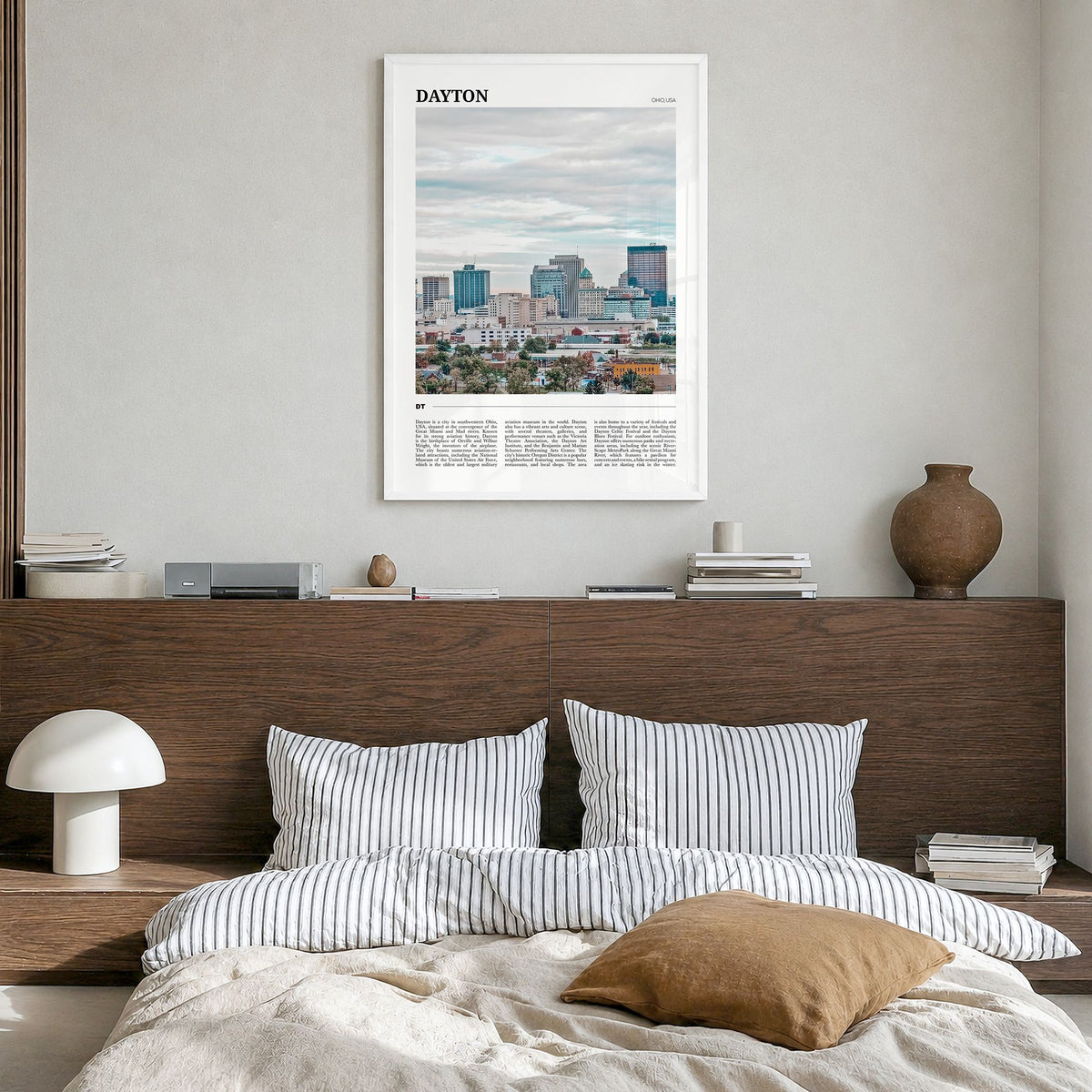 Dayton Travel Poster in a white wood frame, hanging in a bedroom