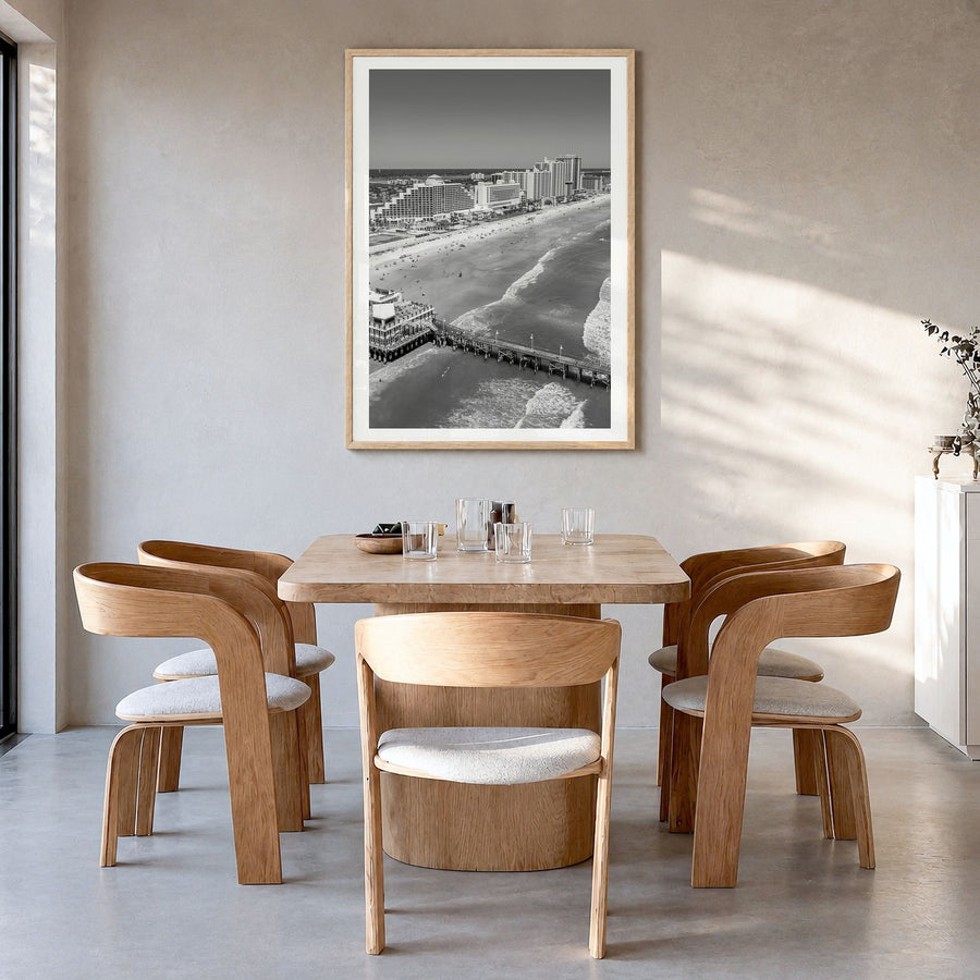Daytona Beach Photo Poster in a natural wood frame, hanging in a dining room, white border