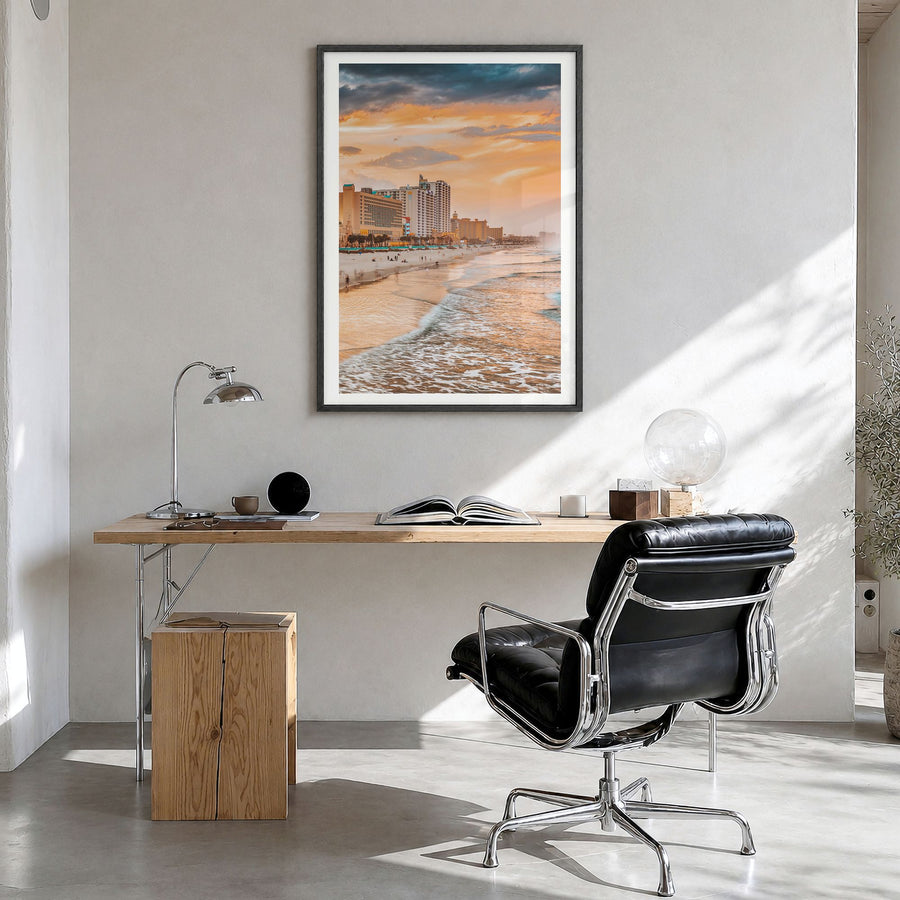 Daytona Beach Photo Poster in a black wood frame, hanging in a bright home office, white border