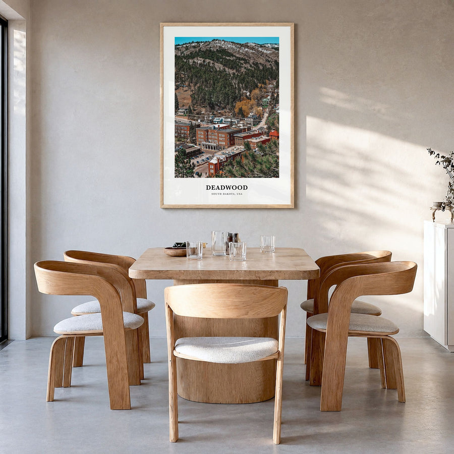 Deadwood Classic Poster in a natural wood frame, hanging in a dining room