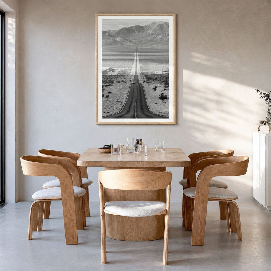 Death Valley Photo Poster in a natural wood frame, hanging in a dining room, white border