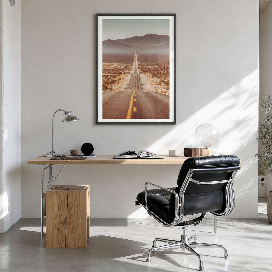 Death Valley Photo Poster in a black wood frame, hanging in a bright home office, white border