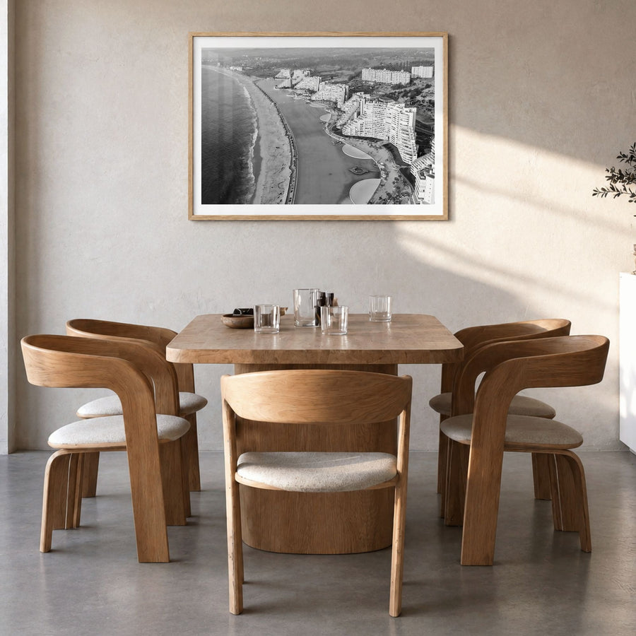 Del Mar Photo Poster in a natural wood frame, hanging in a dining room, white border