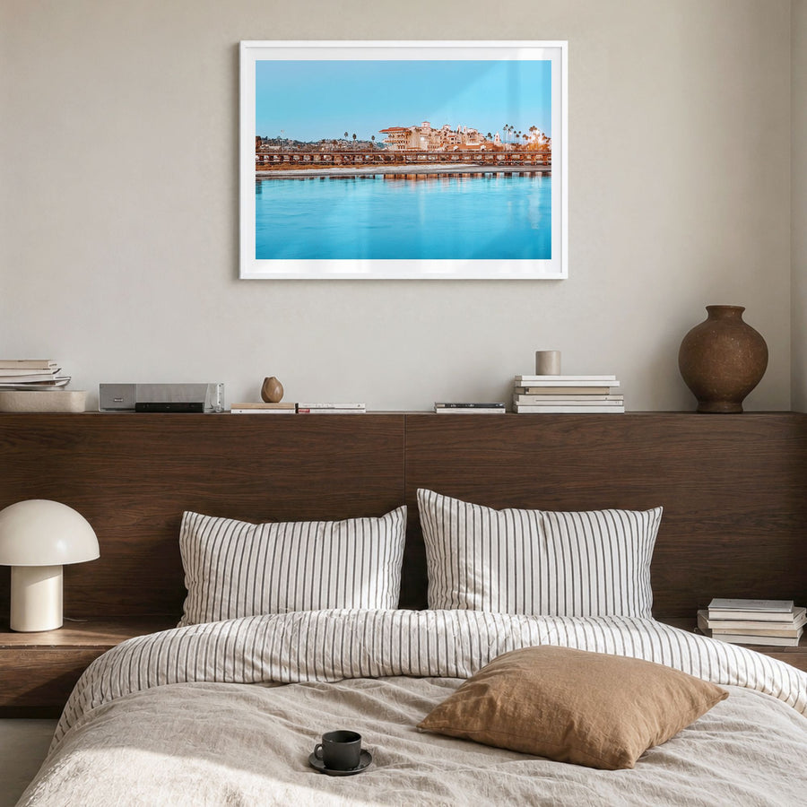 Del Mar Photo Poster in a white wood frame, hanging in a bedroom, white border