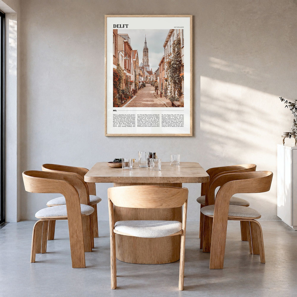Delft Travel Poster in a natural wood frame, hanging in a dining room