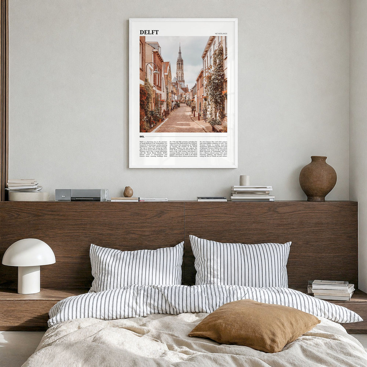 Delft Travel Poster in a white wood frame, hanging in a bedroom