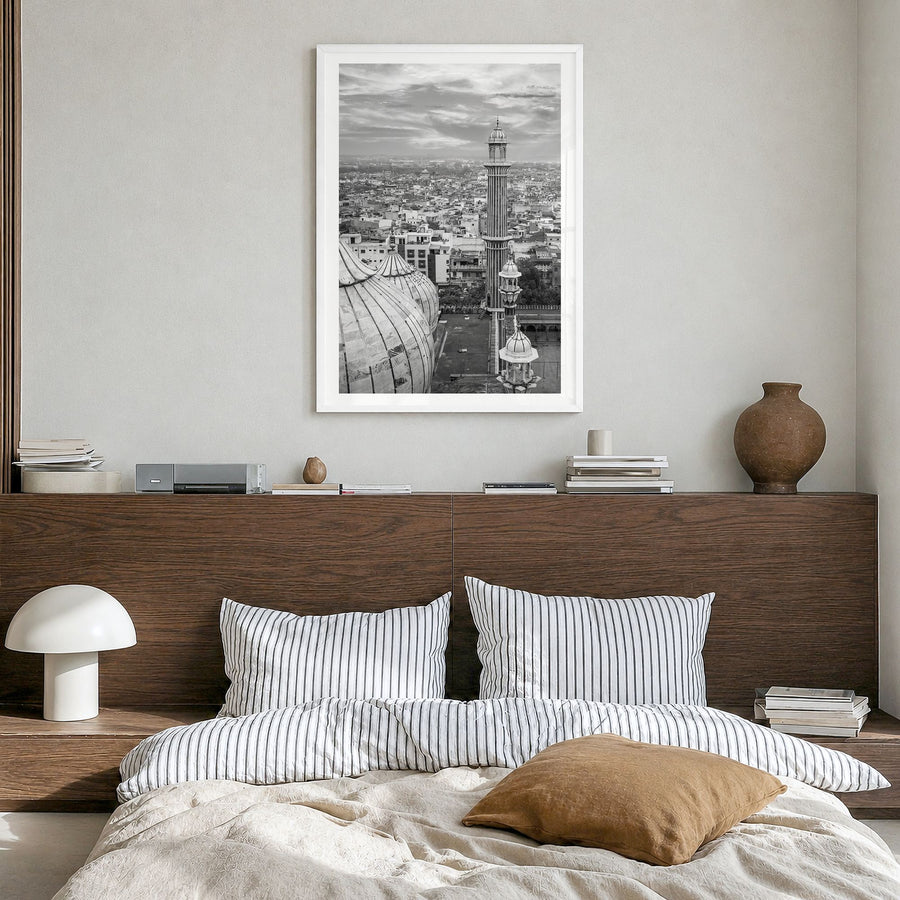 Delhi Photo Poster in a white wood frame, hanging in a bedroom, white border