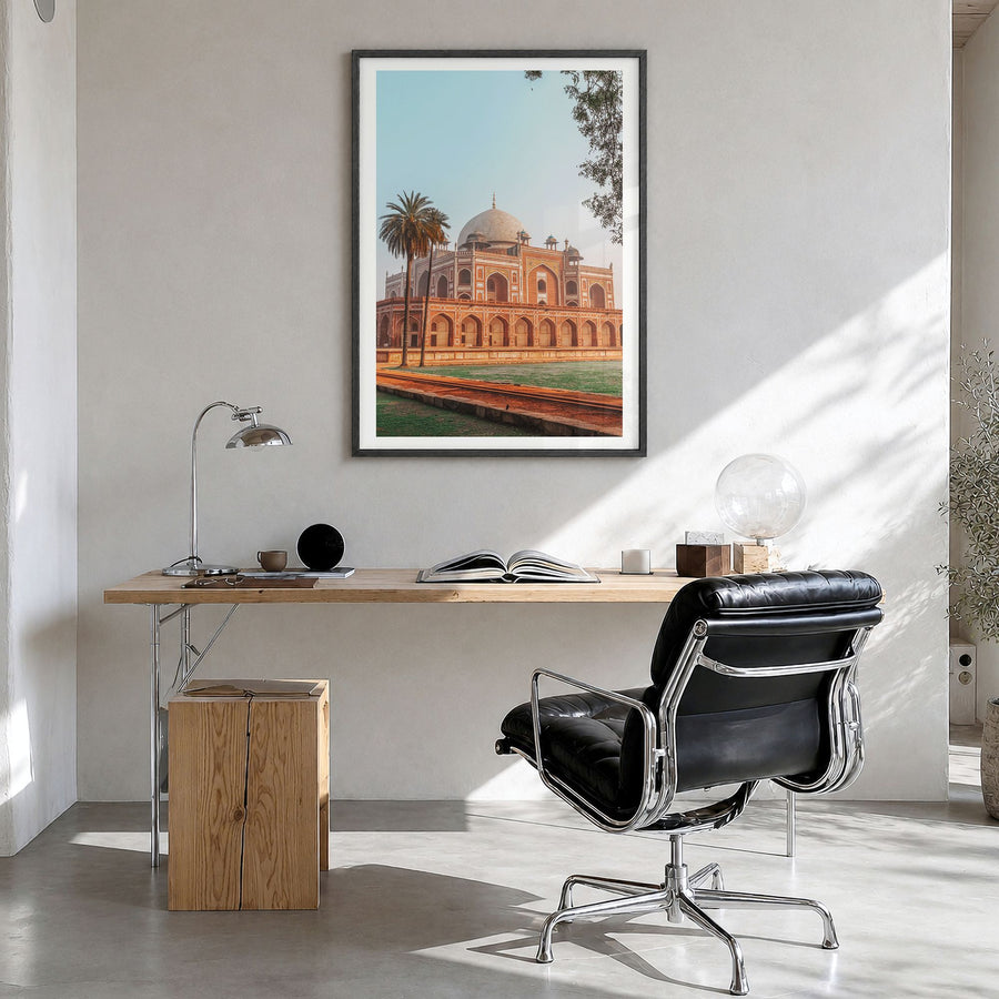 Delhi Photo Poster in a black wood frame, hanging in a bright home office, white border