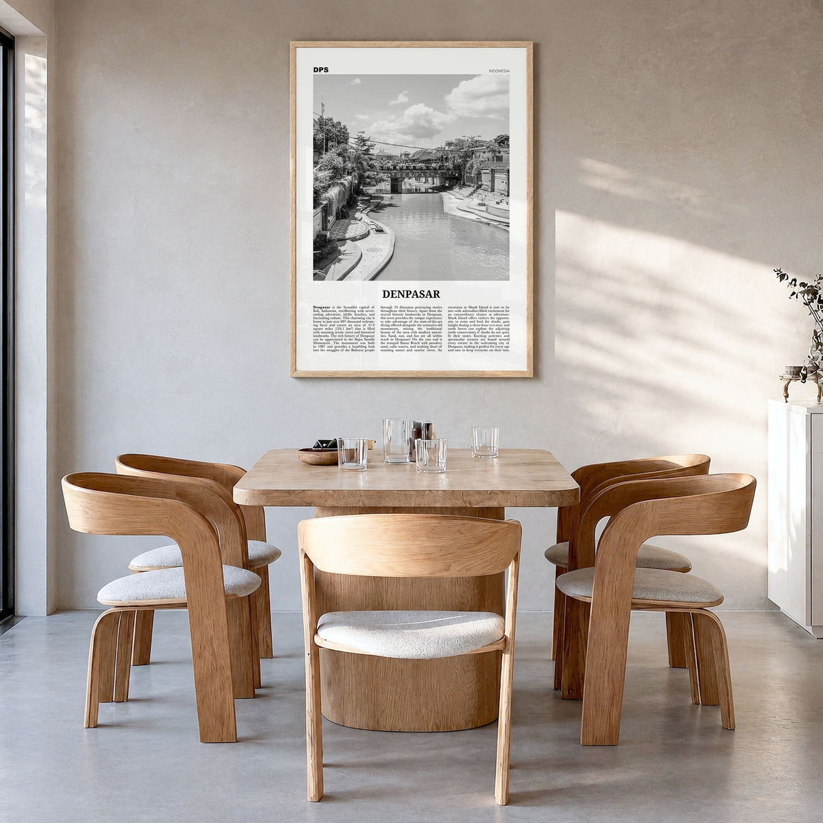 Denpasar Newspaper Poster in a natural wood frame, hanging in a dining room
