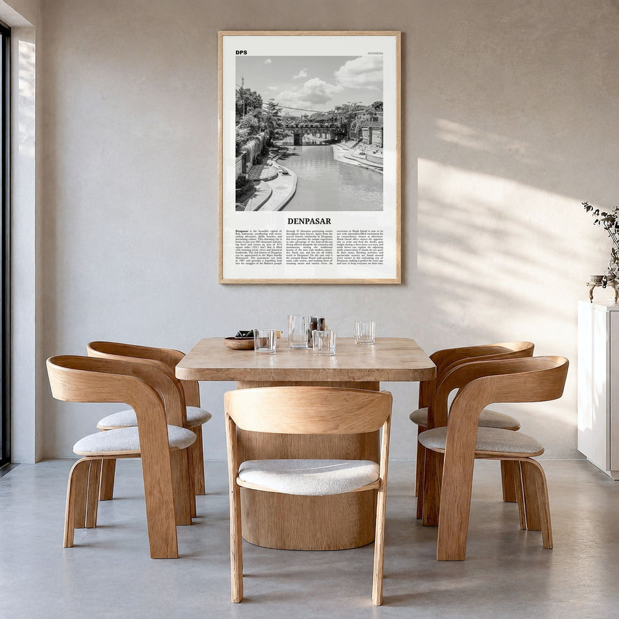Denpasar Newspaper Poster in a natural wood frame, hanging in a dining room