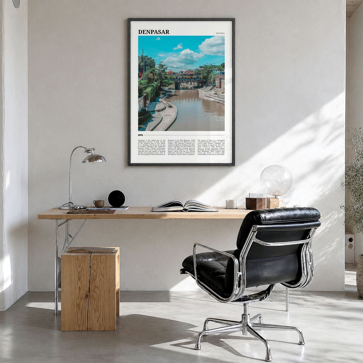 Denpasar Travel Poster in a black wood frame, hanging in a bright home office