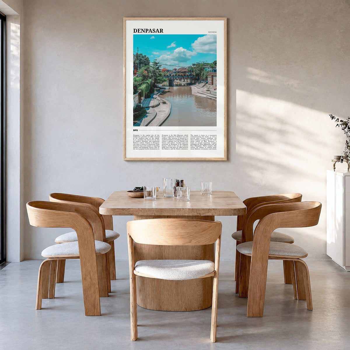 Denpasar Travel Poster in a natural wood frame, hanging in a dining room