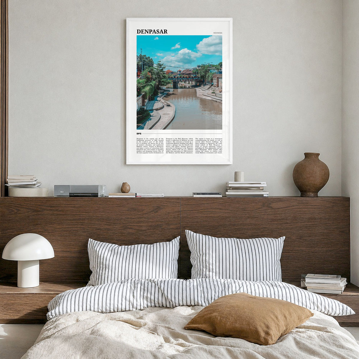 Denpasar Travel Poster in a white wood frame, hanging in a bedroom