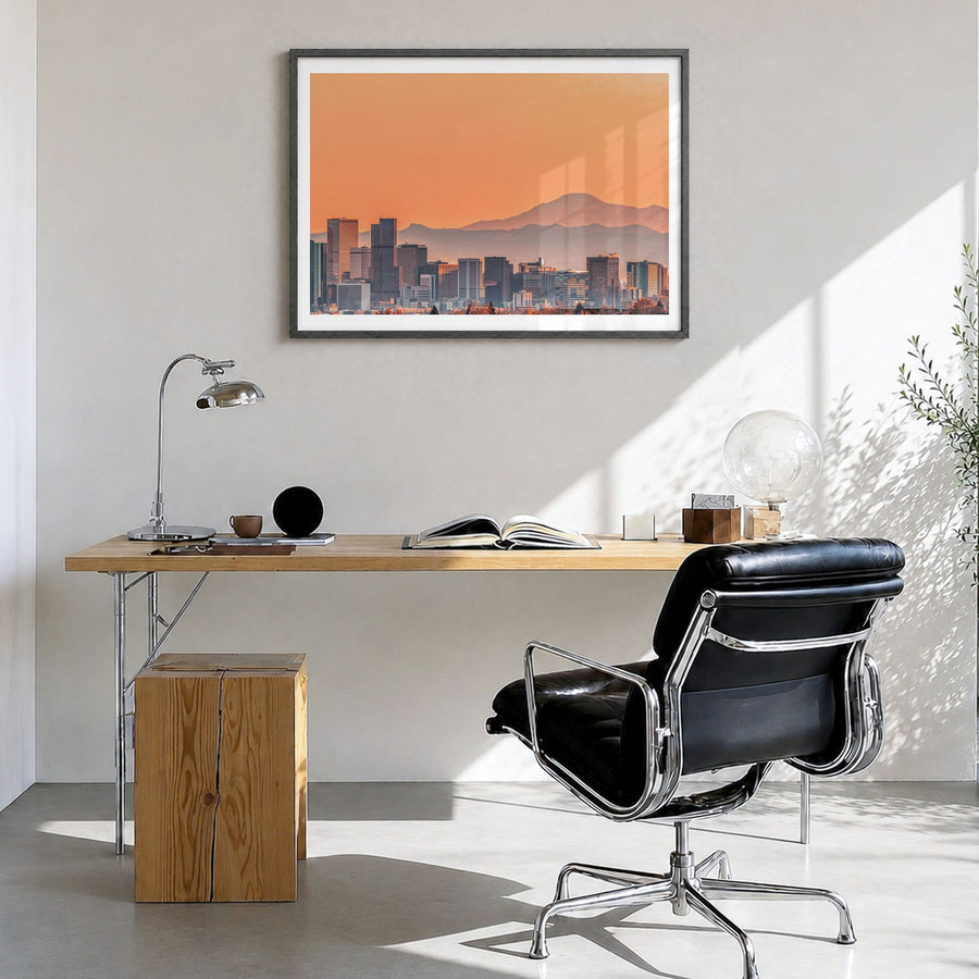 Denver Photo Poster in a black wood frame, hanging in a bright home office, white border