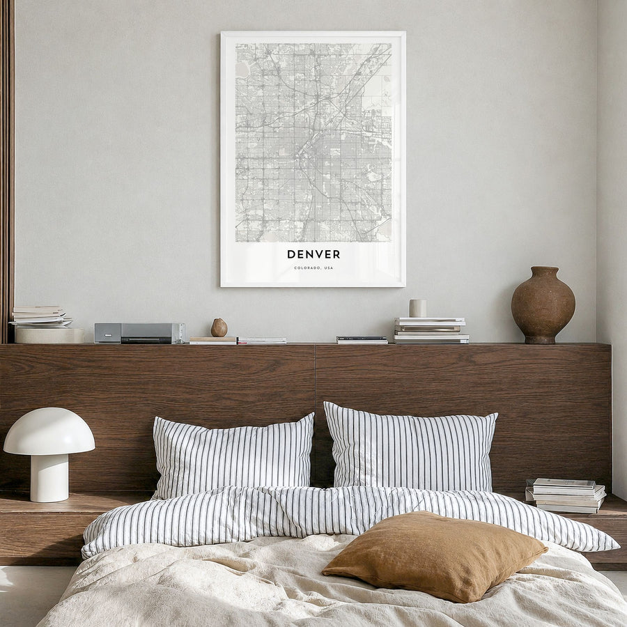 Denver Map Poster in a white wood frame, hanging in a bedroom