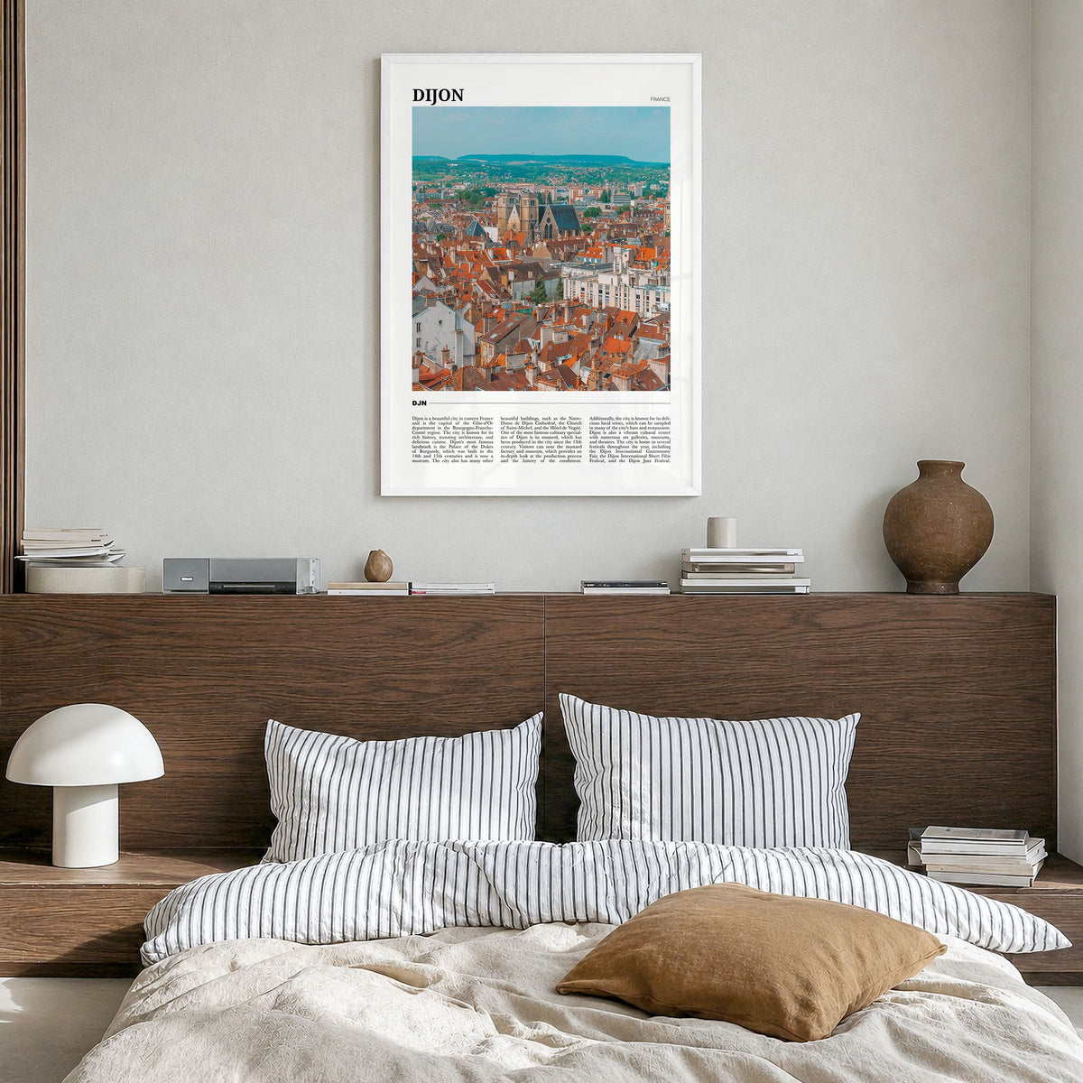 Dijon Travel Poster in a white wood frame, hanging in a bedroom