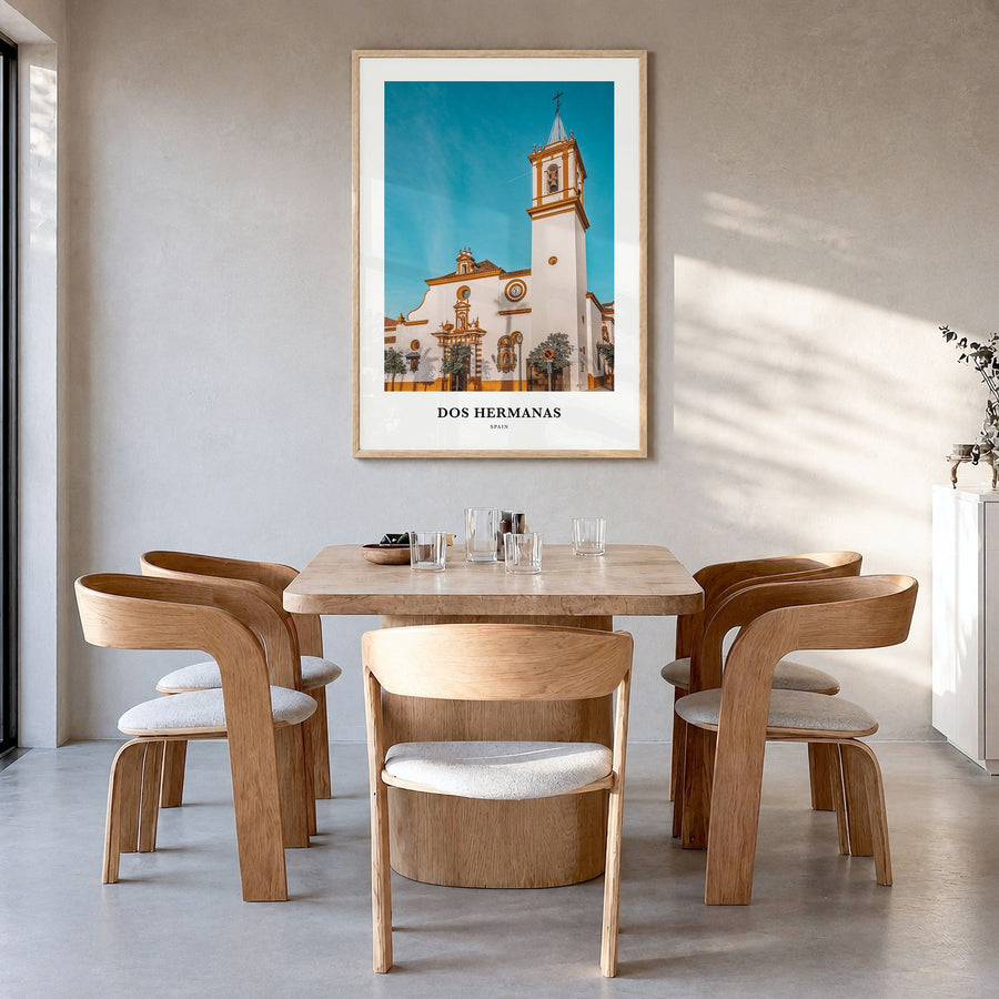 Dos Hermanas Classic Poster in a natural wood frame, hanging in a dining room