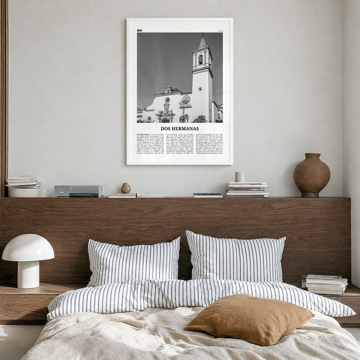 Dos Hermanas Newspaper Poster in a white wood frame, hanging in a bedroom