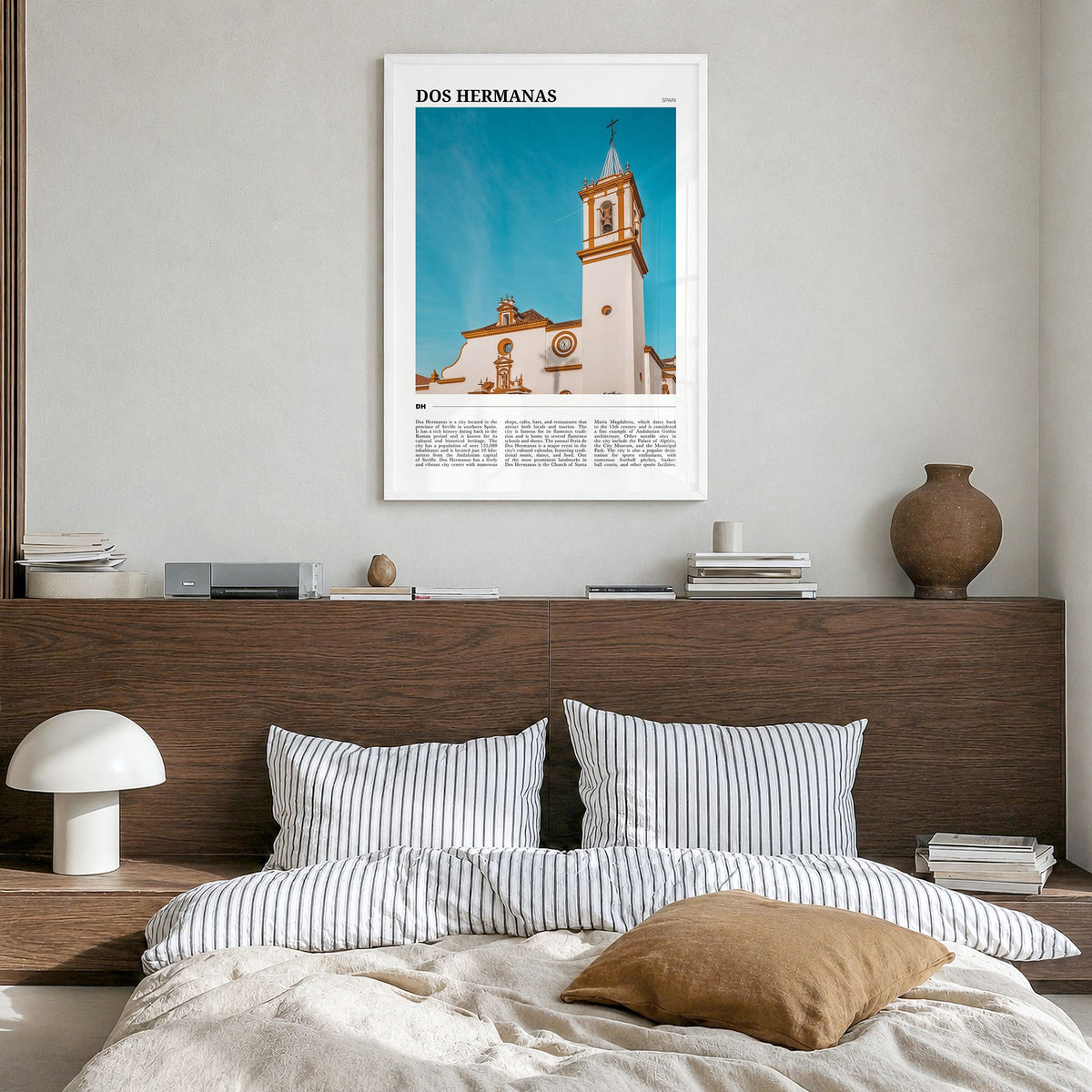Dos Hermanas Travel Poster in a white wood frame, hanging in a bedroom